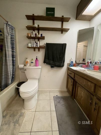 118 Chambers Street Ridgecrest, CA 93555 - Photo 8 of 16 a bathroom with a toilet and a sink