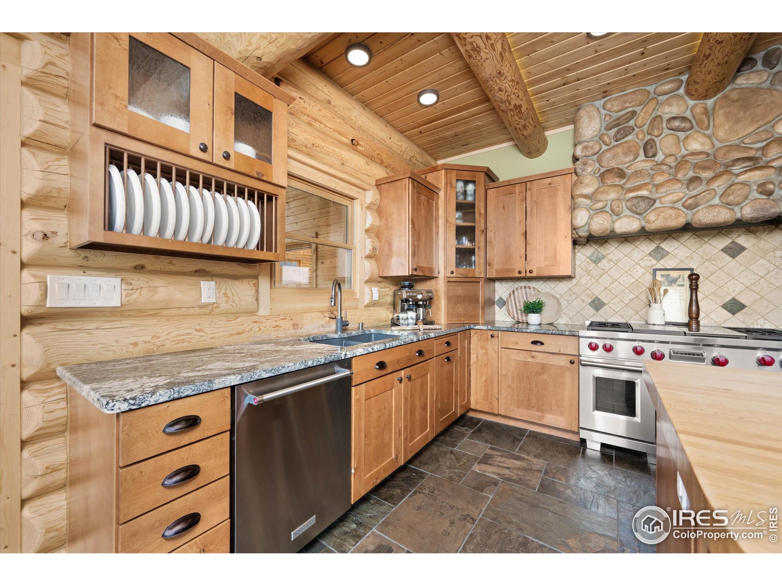 4119 Davis Ranch Road Bellvue, CO 80512 - Photo 12 of 40 a kitchen with stainless steel appliances granite countertop a stove and a sink