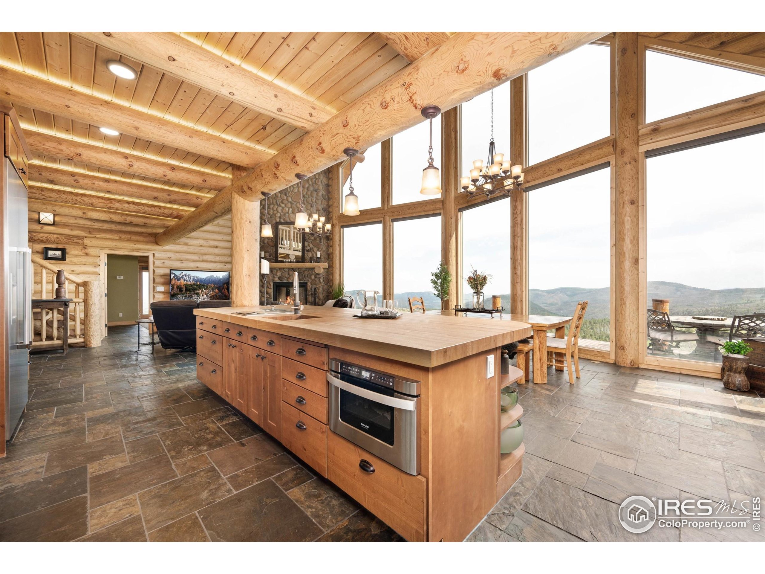 4119 Davis Ranch Road Bellvue, CO 80512 - Photo 15 of 40 a kitchen with stainless steel appliances granite countertop a stove and a view of living room