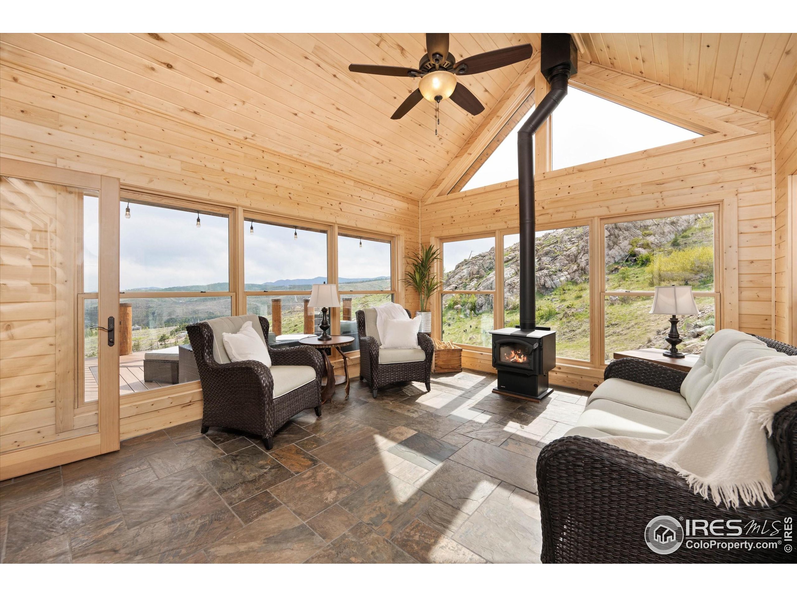 4119 Davis Ranch Road Bellvue, CO 80512 - Photo 16 of 40 a living room with furniture and large windows