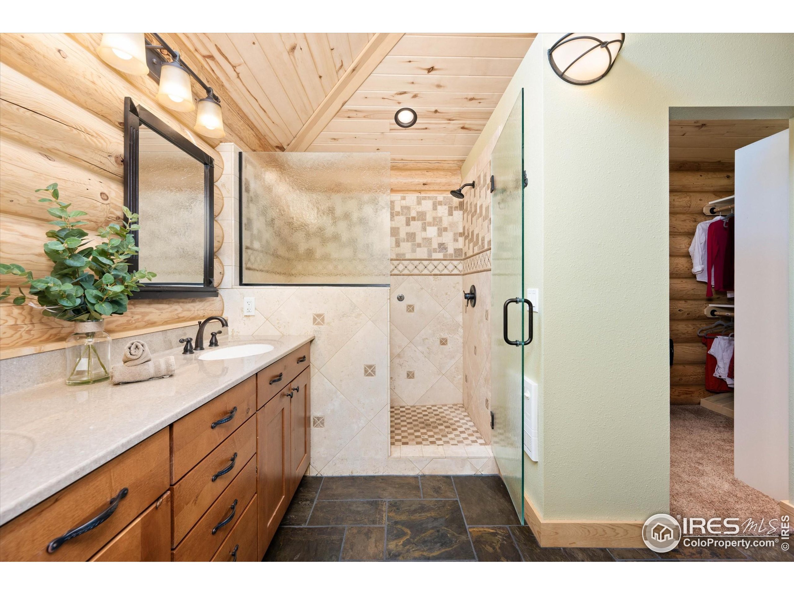 4119 Davis Ranch Road Bellvue, CO 80512 - Photo 21 of 40 a bathroom with a double vanity sink mirror and shower