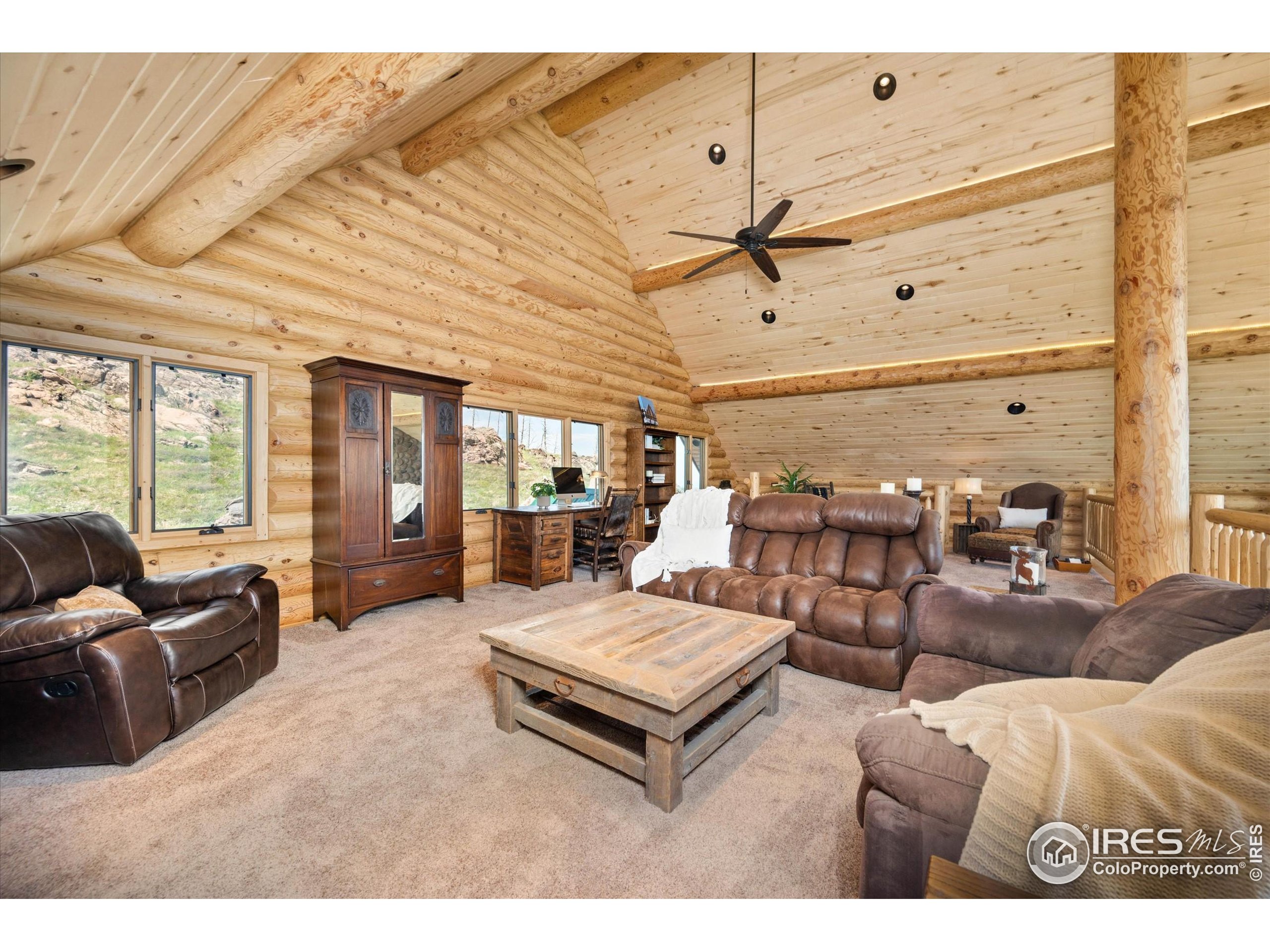 4119 Davis Ranch Road Bellvue, CO 80512 - Photo 25 of 40 a living room with furniture and wooden floor