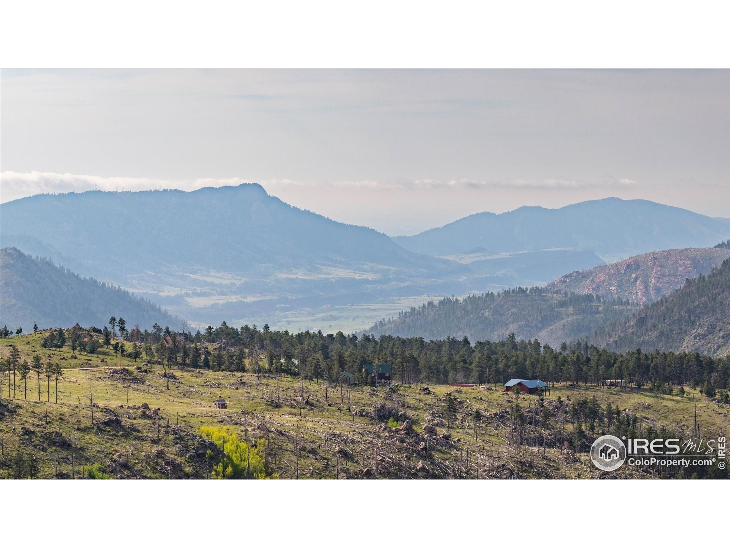 4119 Davis Ranch Road Bellvue, CO 80512 - Photo 28 of 40 a view of a town with mountains in the background