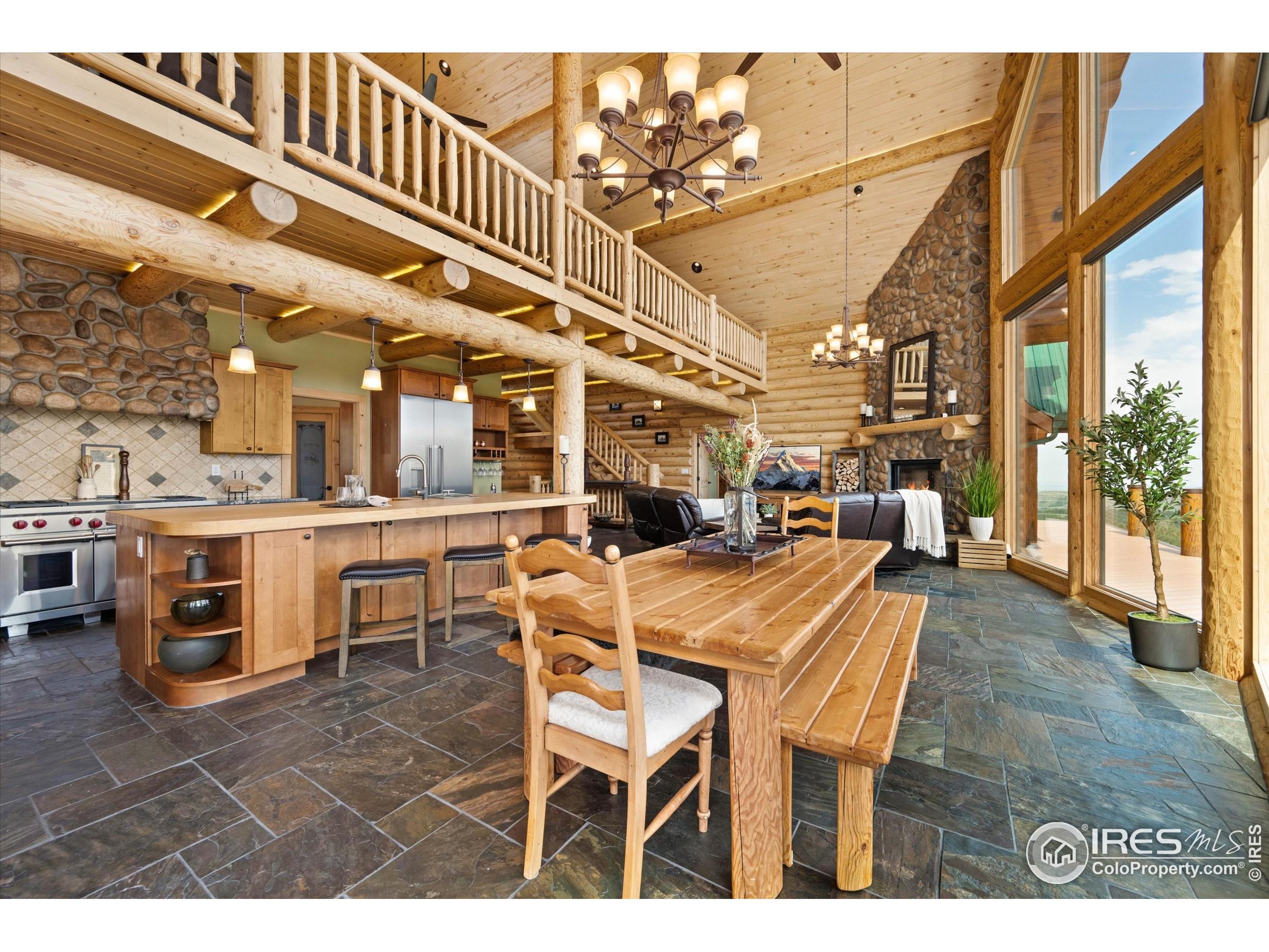 4119 Davis Ranch Road Bellvue, CO 80512 - Photo 10 of 40 a dining hall with stainless steel appliances kitchen island granite countertop a table and chairs