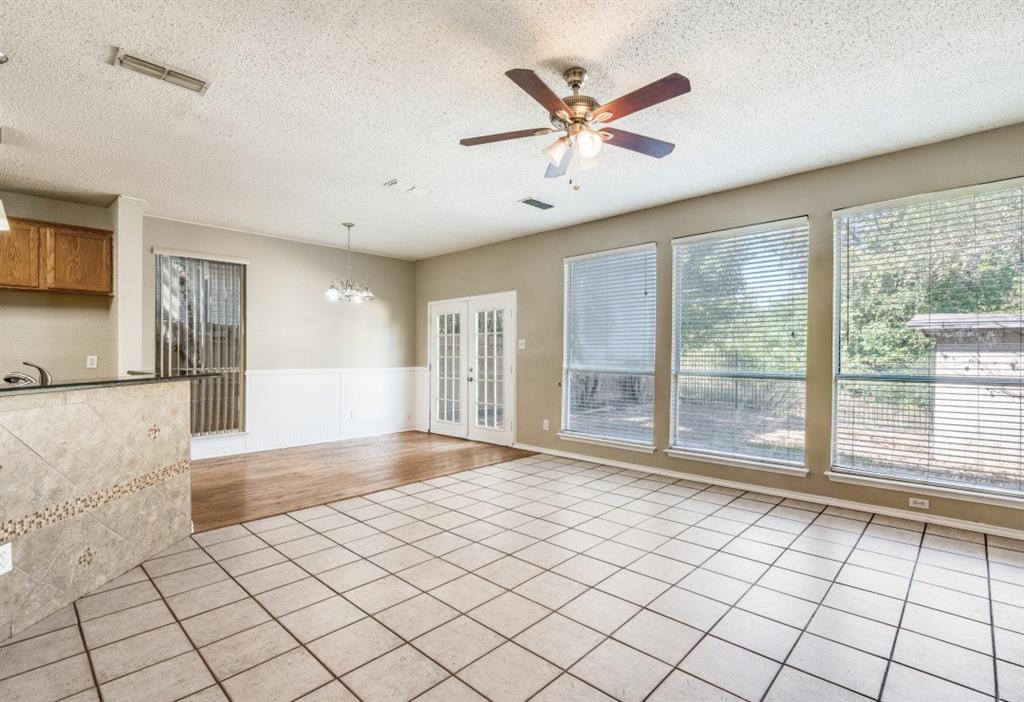 4933 Glenscape Trail Fort Worth, TX 76137 - Photo 5 of 12 a view of empty room with wooden floor and fan