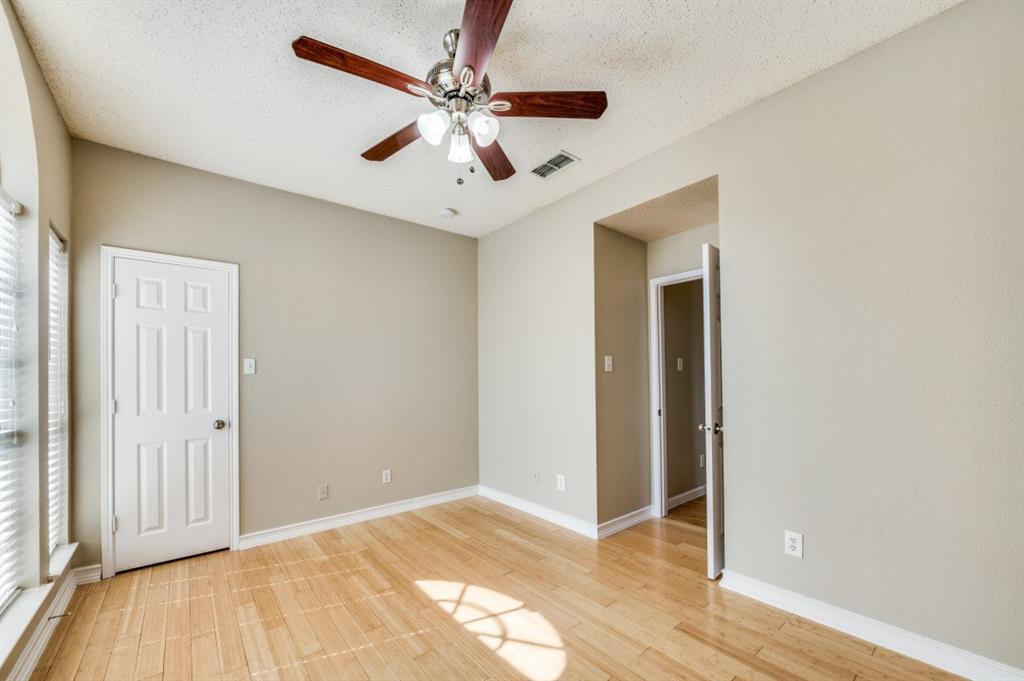4933 Glenscape Trail Fort Worth, TX 76137 - Photo 8 of 12 wooden floor in an empty room with a window