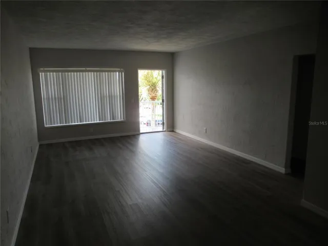 a kitchen with granite countertop white cabinets and white stainless steel appliances