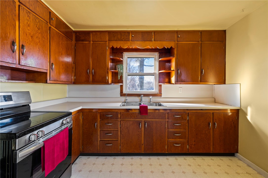 10797 Gratis Jacksonburg Road Somerville, OH 45064 - Photo 11 of 27 This spacious kitchen offers ample cabinetry and an electric range for effortless meal preparation.