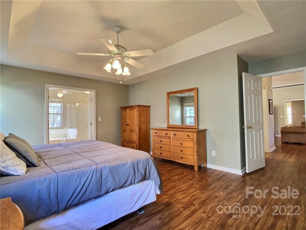 870 Knightsbridge Road Fort Mill, SC 29708 - Photo 14 of 25 a spacious bedroom with a bed and wooden floor