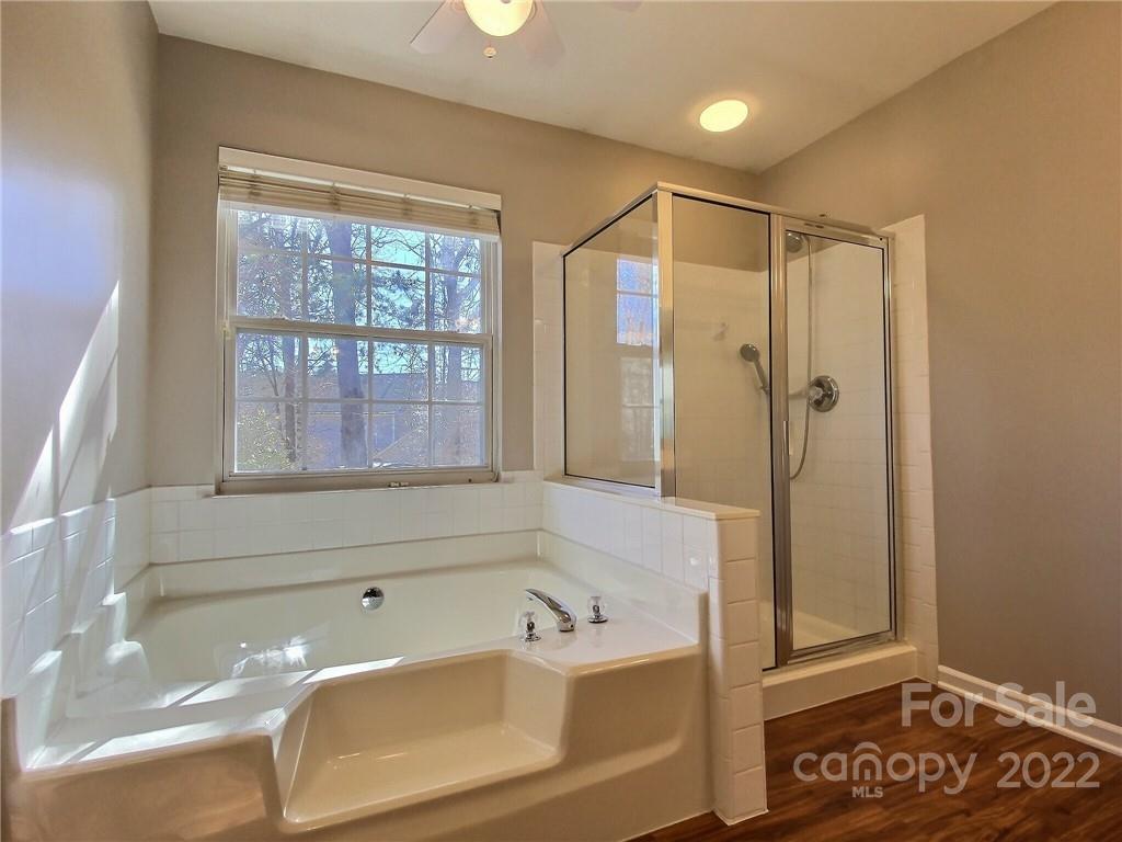 870 Knightsbridge Road Fort Mill, SC 29708 - Photo 15 of 25 a bathroom with a tub a sink and a large window
