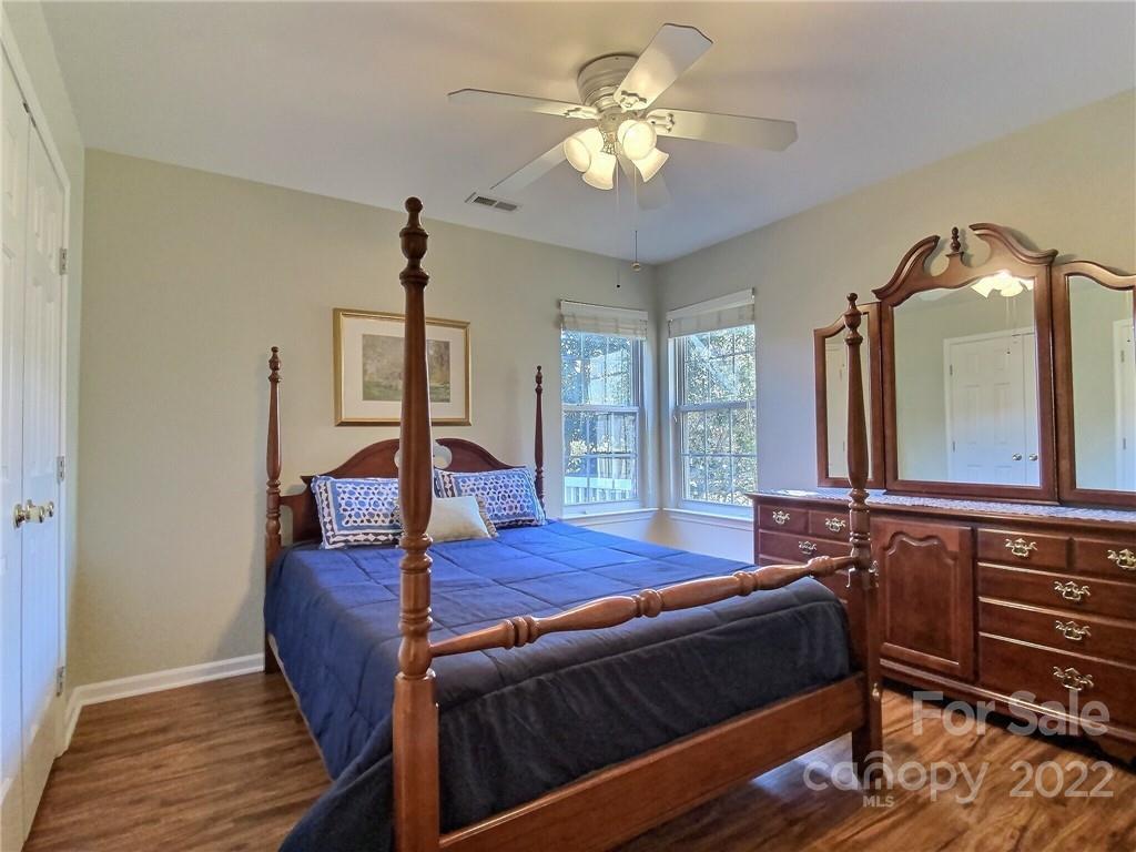 870 Knightsbridge Road Fort Mill, SC 29708 - Photo 20 of 25 a bedroom with a bed a chandelier and dresser