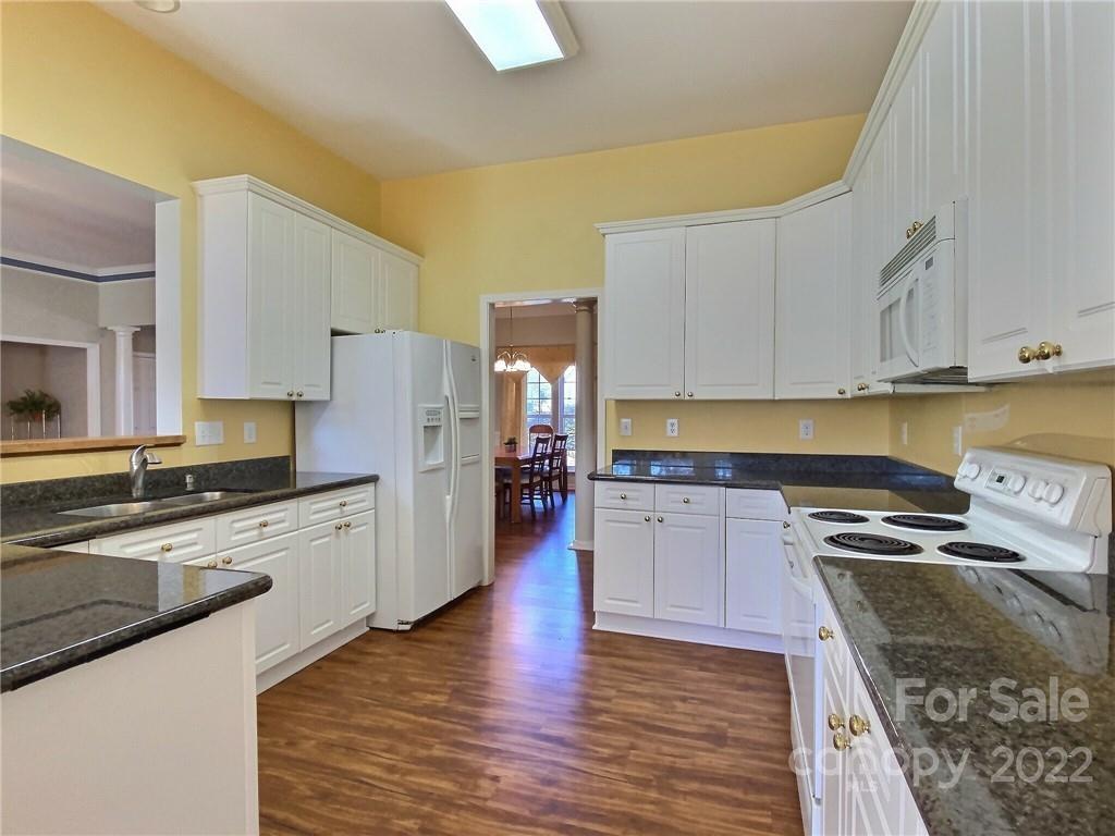 870 Knightsbridge Road Fort Mill, SC 29708 - Photo 8 of 25 a kitchen with stainless steel appliances granite countertop a stove a sink and a refrigerator