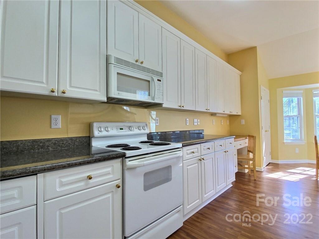 870 Knightsbridge Road Fort Mill, SC 29708 - Photo 9 of 25 a kitchen with granite countertop white cabinets and white appliances