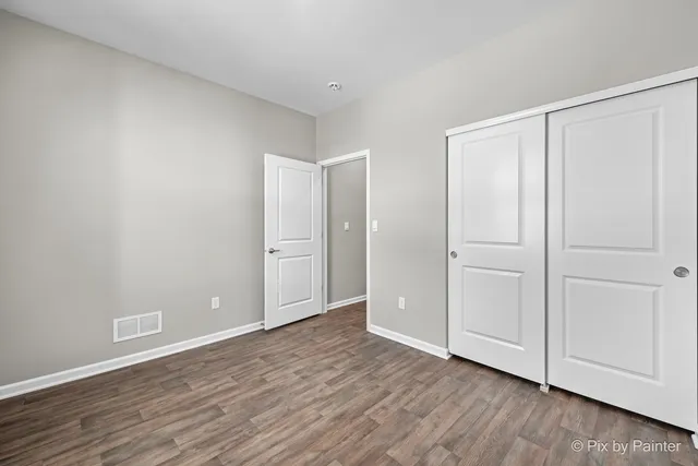 a view of an empty room and wooden floor