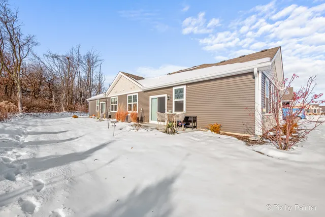 a view of a house with a snow in the background