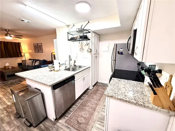 a kitchen with sink and refrigerator