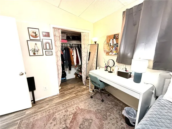 a bedroom with a bed and flat screen tv