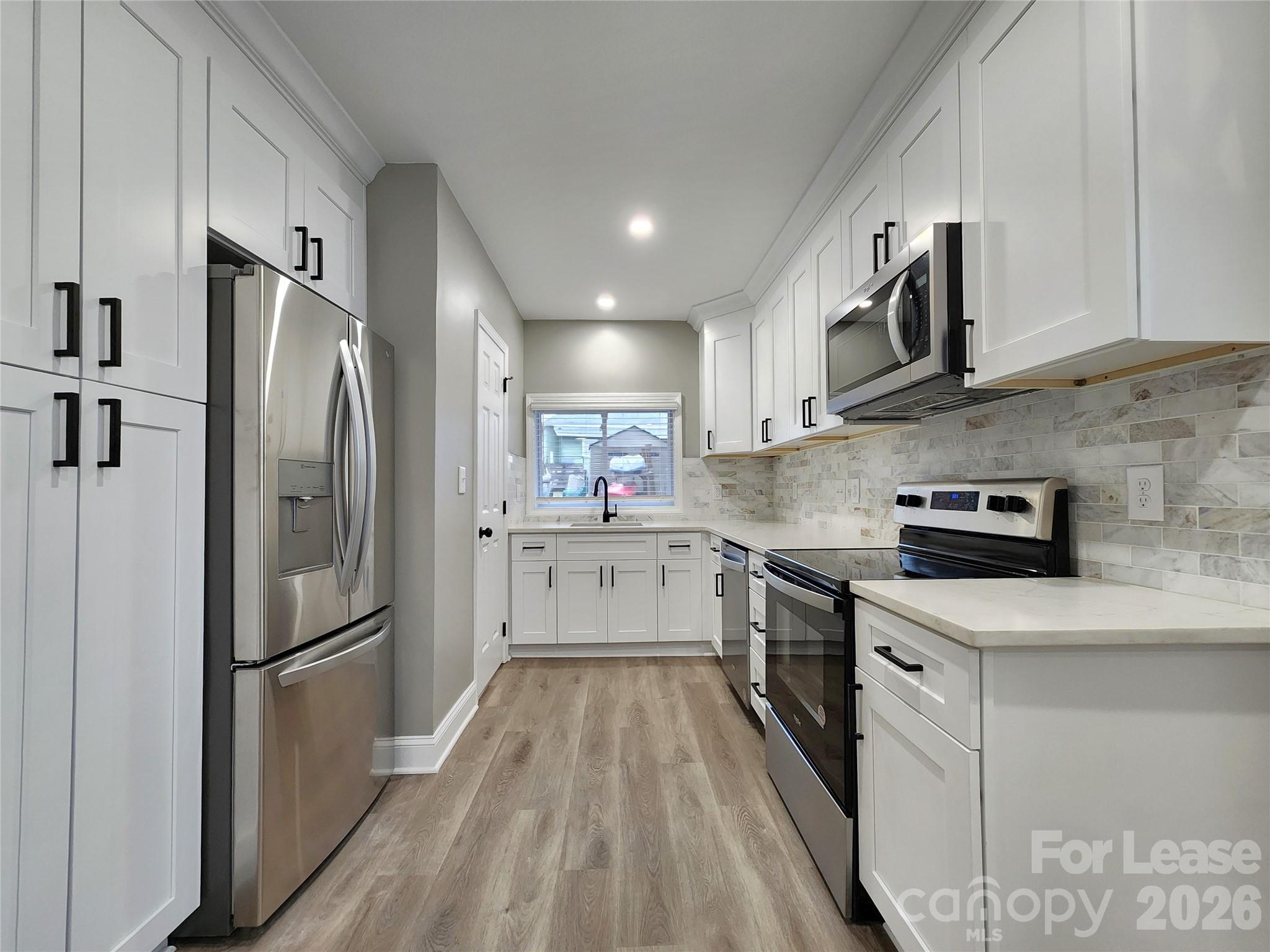 96 1/2 Elm Street Cramerton, NC 28032 - Photo 1 of 20 a kitchen with stainless steel appliances a refrigerator sink and microwave