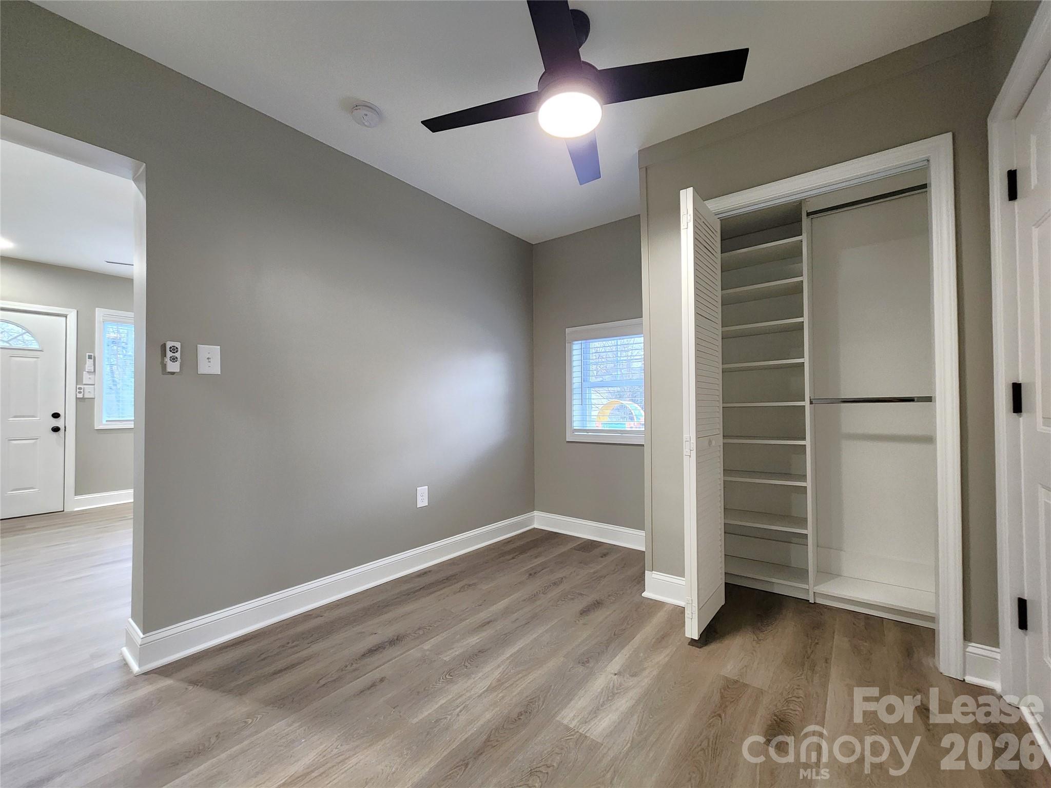 96 1/2 Elm Street Cramerton, NC 28032 - Photo 11 of 20 an empty room with wooden floor closet and windows