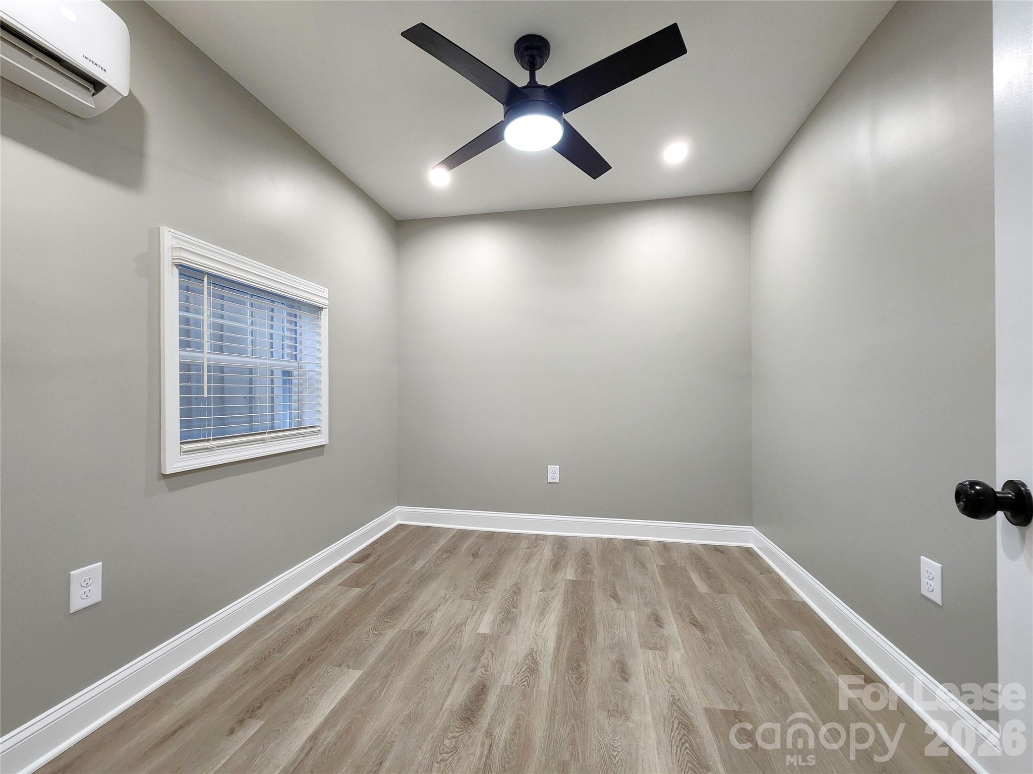 96 1/2 Elm Street Cramerton, NC 28032 - Photo 15 of 20 an empty room with wooden floor and windows