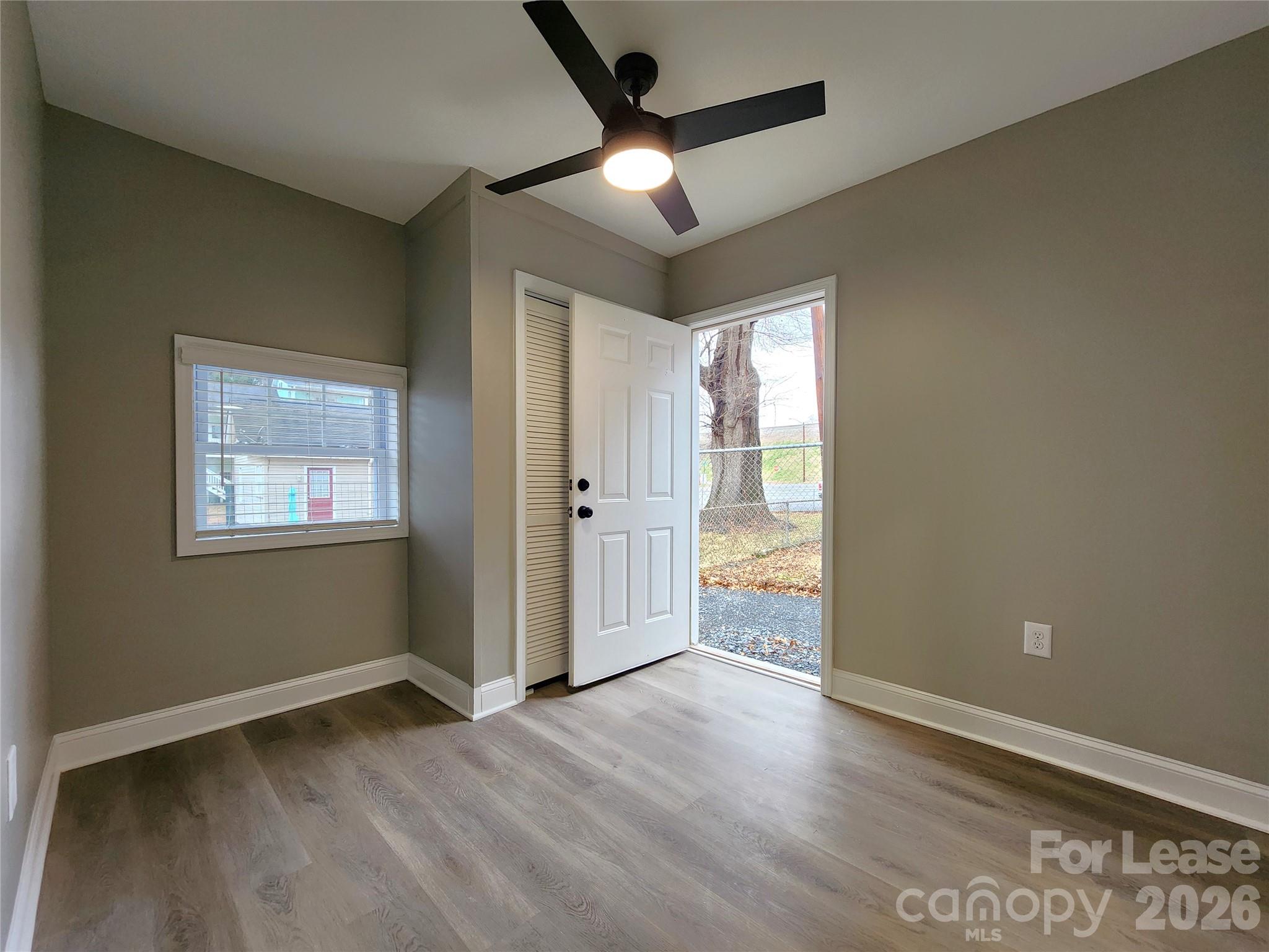 96 1/2 Elm Street Cramerton, NC 28032 - Photo 17 of 20 an empty room with wooden floor and windows