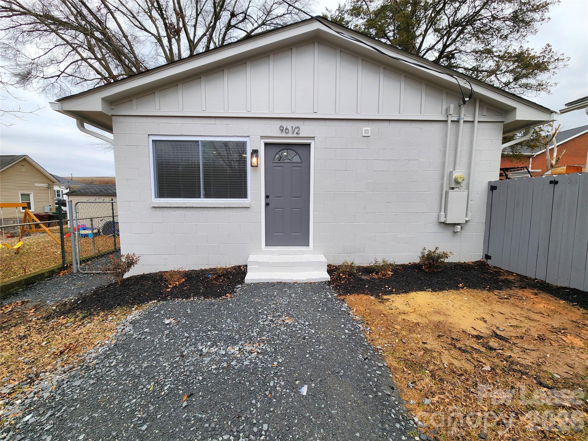 96 1/2 Elm Street Cramerton, NC 28032 - Photo 2 of 20 a front view of a house with a yard and garage