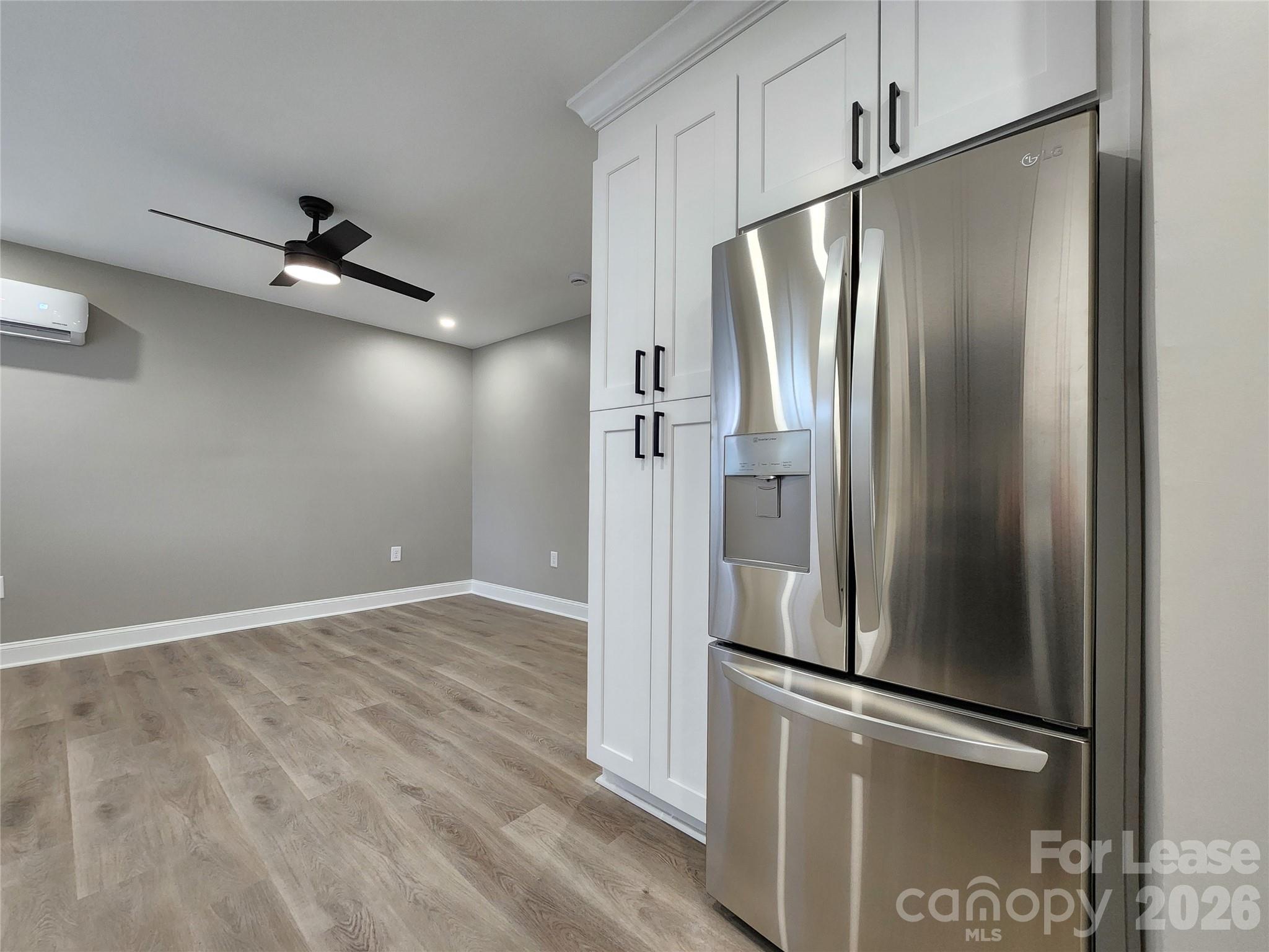 96 1/2 Elm Street Cramerton, NC 28032 - Photo 6 of 20 a kitchen with stainless steel appliances a refrigerator and a ceiling fan