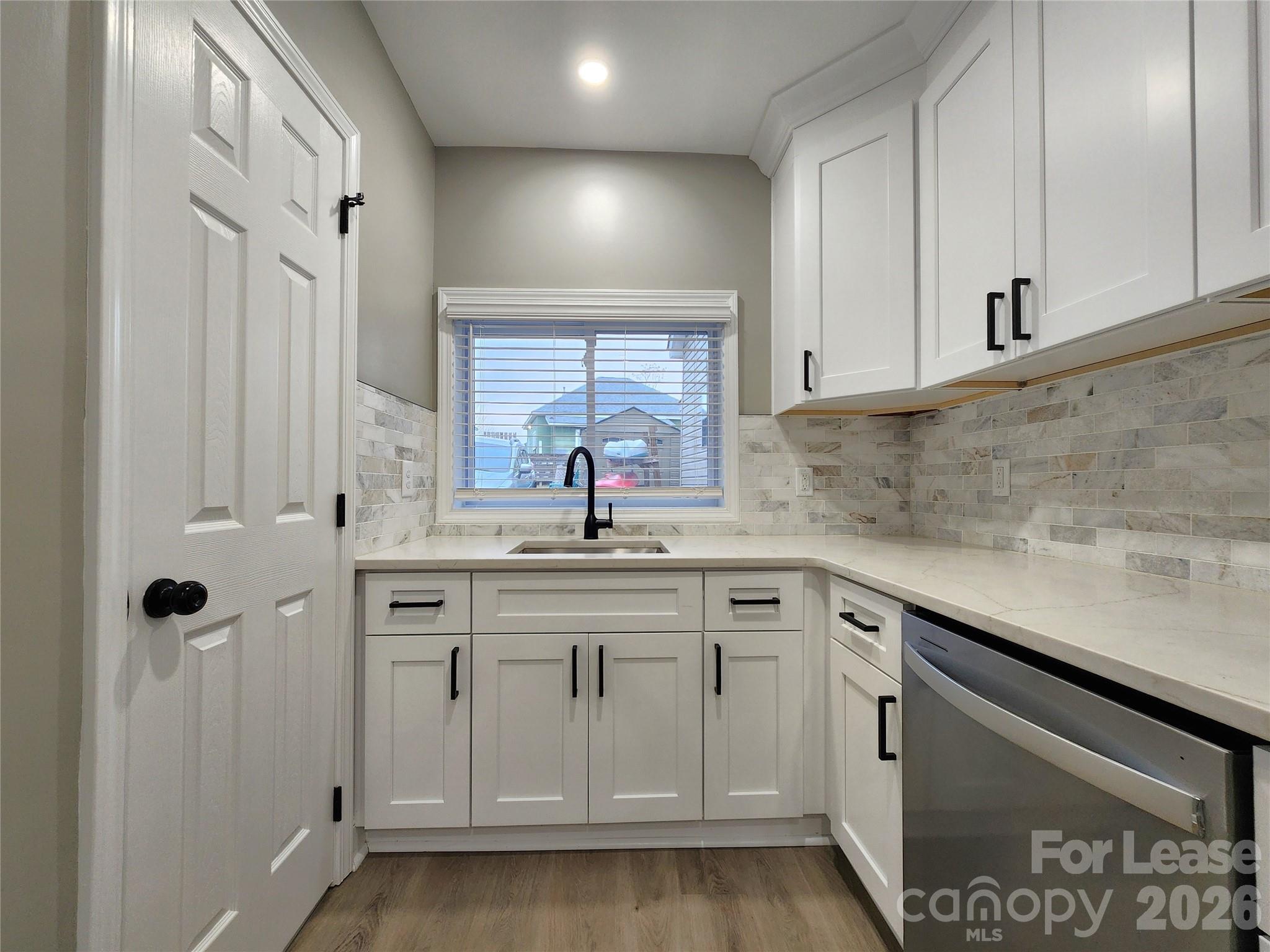 96 1/2 Elm Street Cramerton, NC 28032 - Photo 7 of 20 a kitchen with white cabinets and sink
