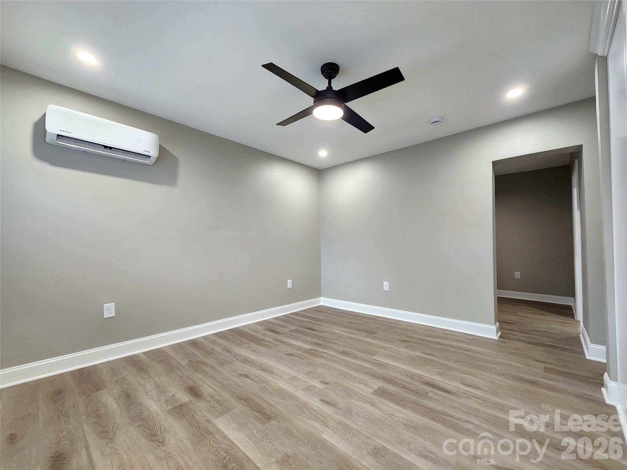 96 1/2 Elm Street Cramerton, NC 28032 - Photo 8 of 20 an empty room with wooden floor and a ceiling fan
