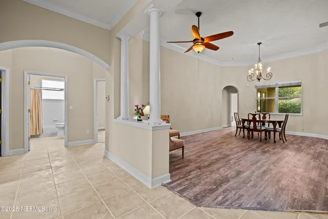 a view of a livingroom with furniture and a ceiling fan a fireplace