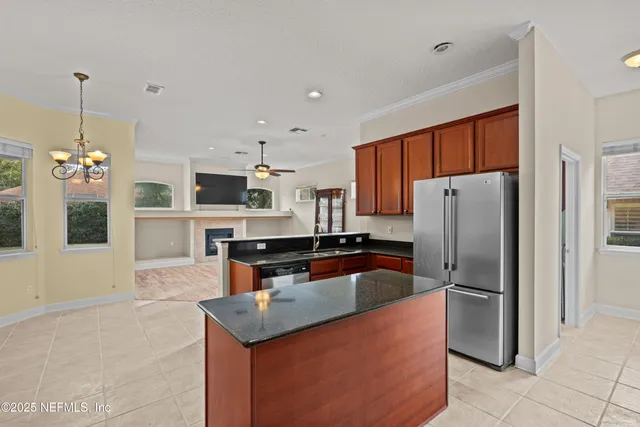 a kitchen with stainless steel appliances granite countertop a refrigerator a stove and a sink