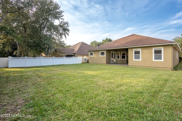 a view of a house with a backyard