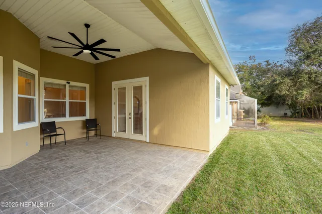 a view of a house with backyard and porch