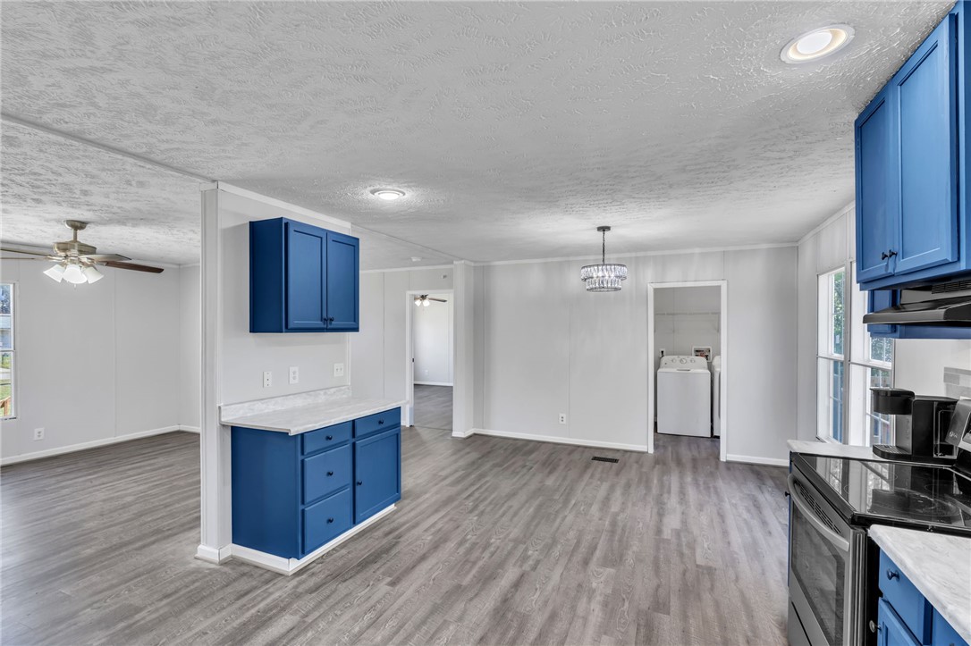 This bright, open living space features beautiful flooring and a vibrant kitchen.