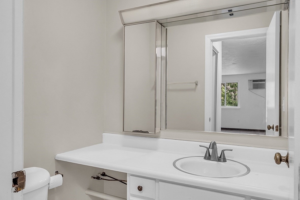 10 Mill Street, Unit B Maynard, MA 01754 - Photo 17 of 21 a bathroom with a sink and a mirror