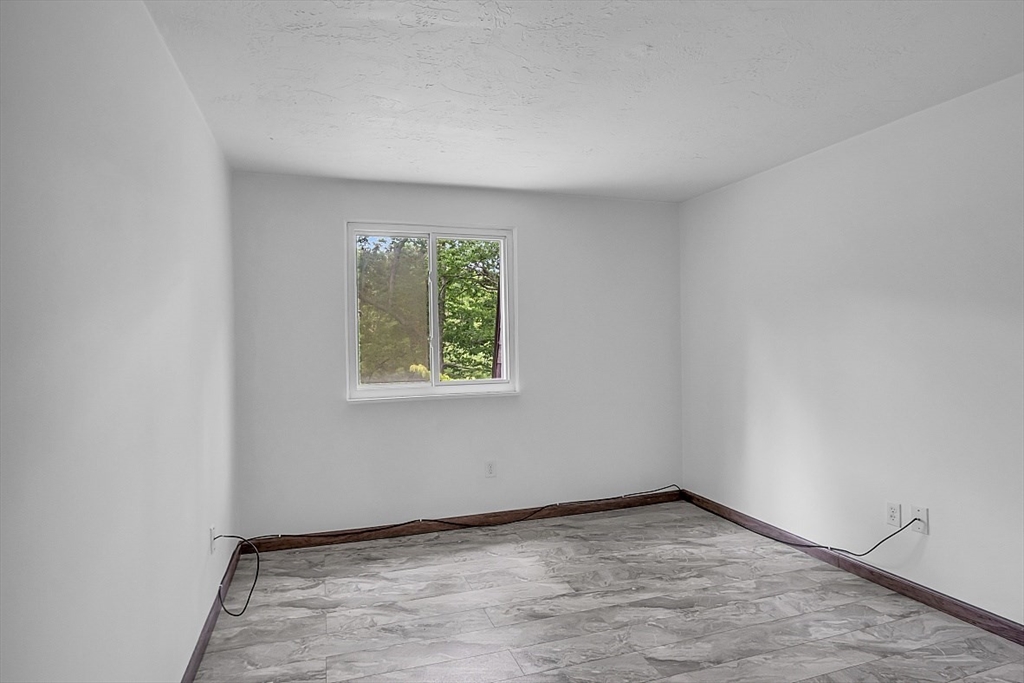 10 Mill Street, Unit B Maynard, MA 01754 - Photo 18 of 21 a view of an empty room with a window