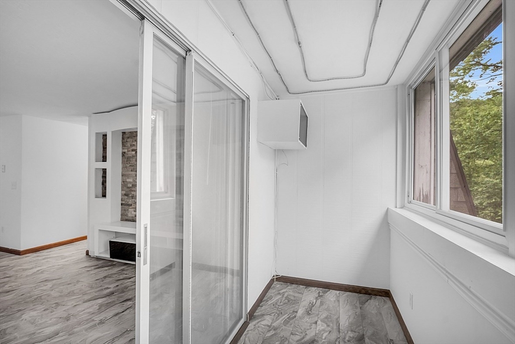 10 Mill Street, Unit B Maynard, MA 01754 - Photo 20 of 21 a view of a hallway with wooden floor and entryway