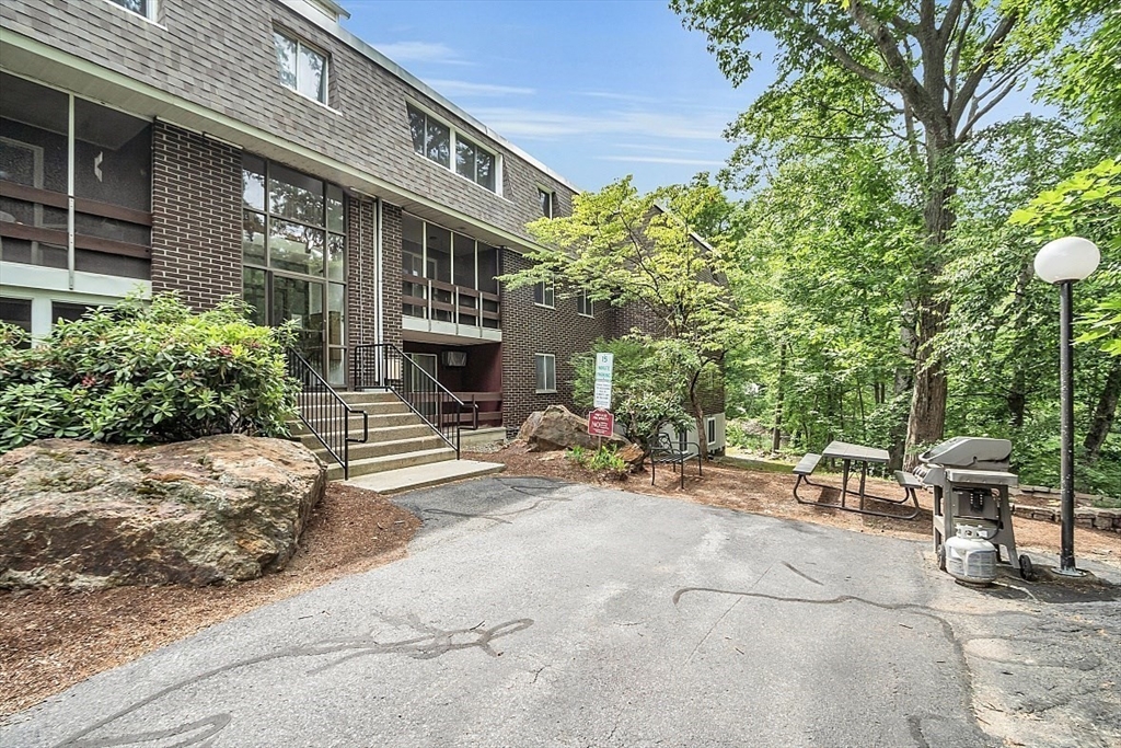 10 Mill Street, Unit B Maynard, MA 01754 - Photo 2 of 21 a view of a patio with table and chairs and potted plants