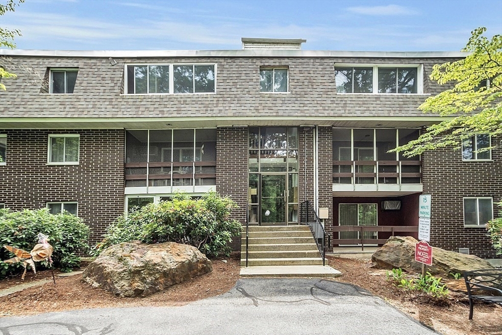 10 Mill Street, Unit B Maynard, MA 01754 - Photo 3 of 21 a front view of a house with a yard