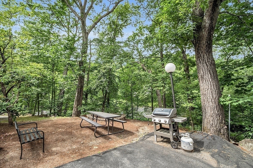 10 Mill Street, Unit B Maynard, MA 01754 - Photo 4 of 21 a view of a bench in a backyard