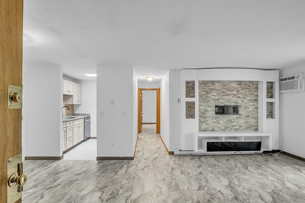 10 Mill Street, Unit B Maynard, MA 01754 - Photo 6 of 21 an empty room with furniture and a fireplace