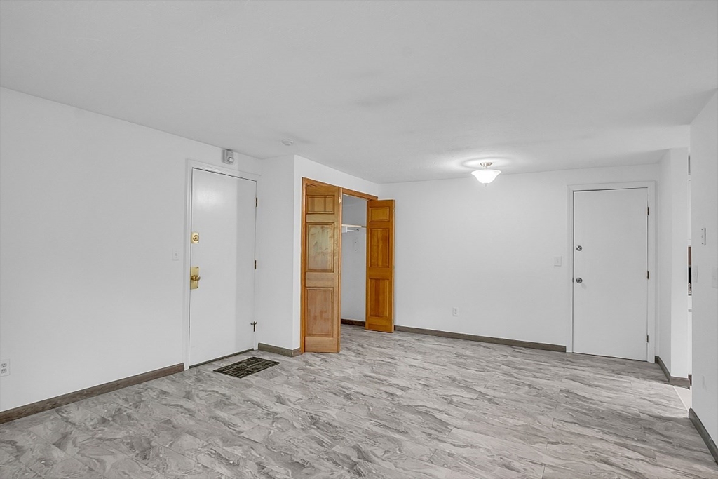 10 Mill Street, Unit B Maynard, MA 01754 - Photo 7 of 21 a view of an empty room and wooden floor