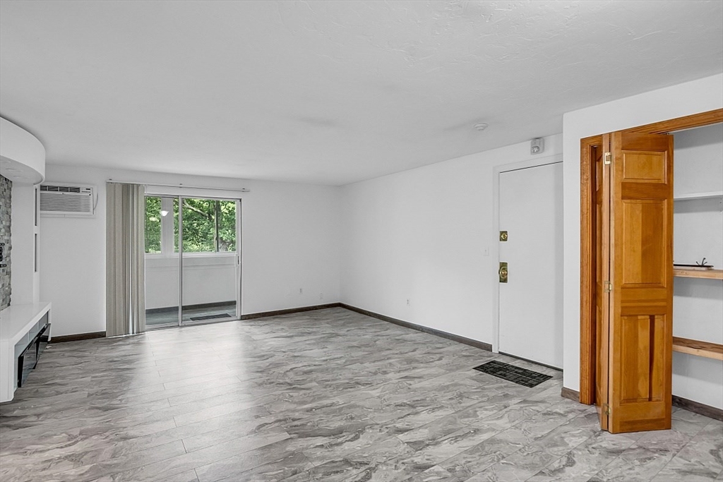 10 Mill Street, Unit B Maynard, MA 01754 - Photo 8 of 21 a view of an empty room with wooden floor and a window