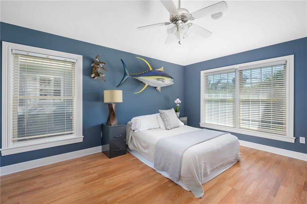 5440 95th Street Sebastian, FL 32958 - Photo 19 of 36 a bedroom with a large bed and a chandelier