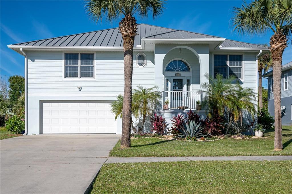 5440 95th Street Sebastian, FL 32958 - Photo 2 of 36 a front view of a house with a garden