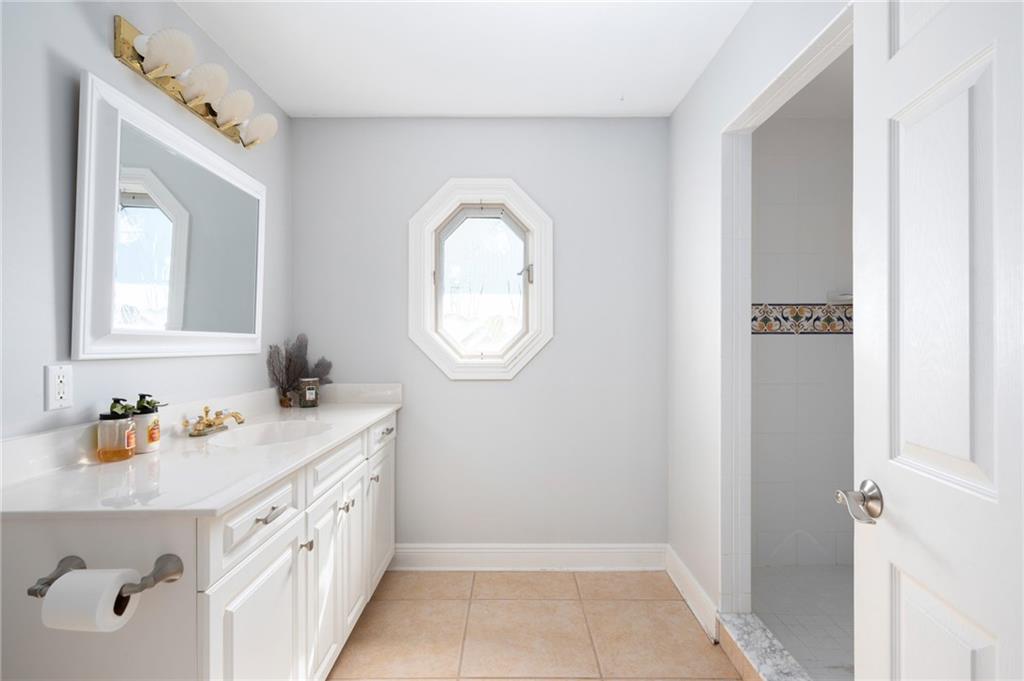 5440 95th Street Sebastian, FL 32958 - Photo 22 of 36 a bathroom with a sink and a mirror