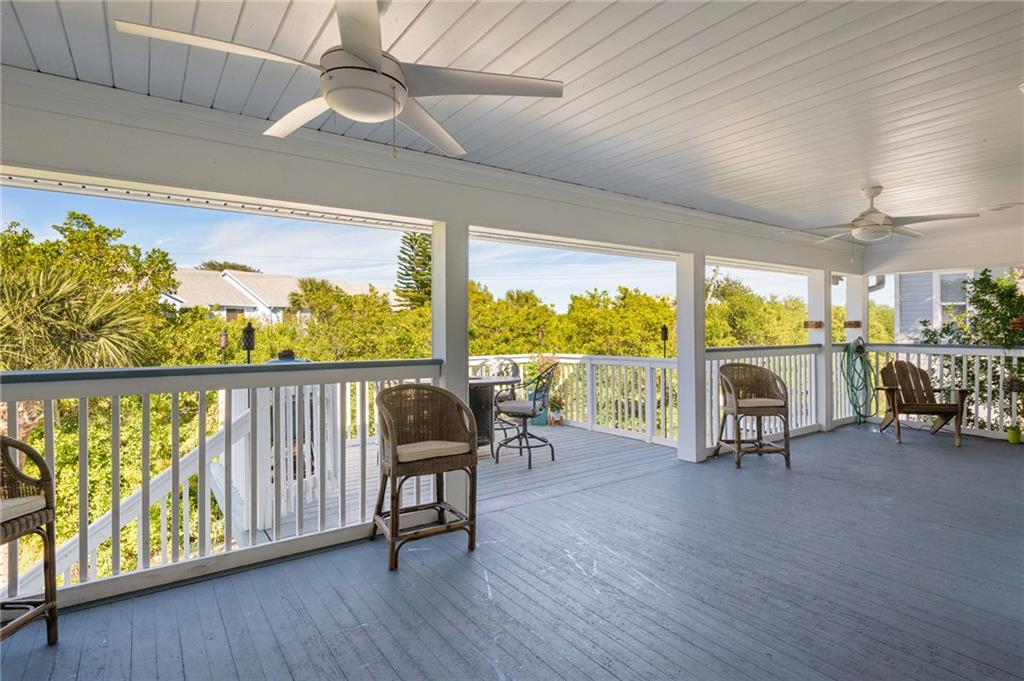 5440 95th Street Sebastian, FL 32958 - Photo 26 of 36 a living room with furniture and a floor to ceiling window