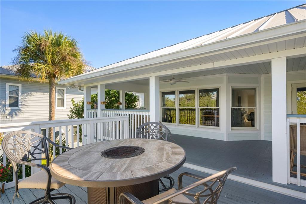 5440 95th Street Sebastian, FL 32958 - Photo 27 of 36 a view of a house with a wooden deck and furniture