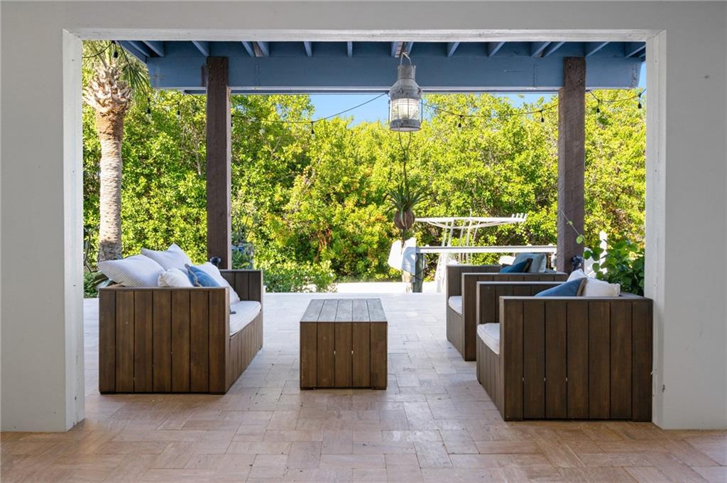 5440 95th Street Sebastian, FL 32958 - Photo 31 of 36 a view of a porch with wooden floor and furniture