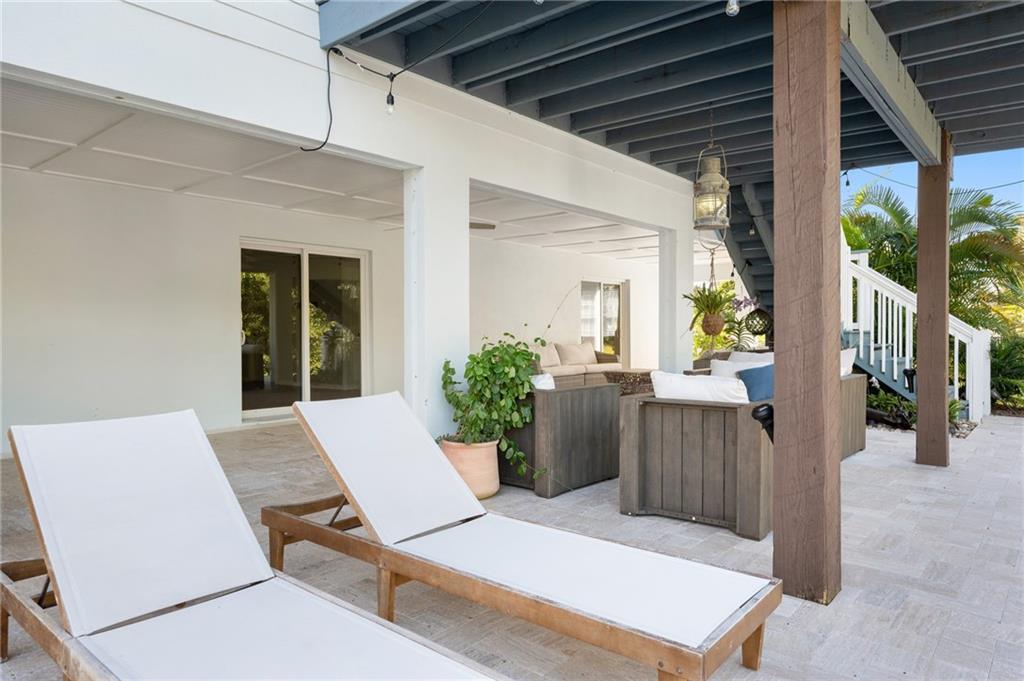 5440 95th Street Sebastian, FL 32958 - Photo 32 of 36 a view of a patio with table and chairs in front of house